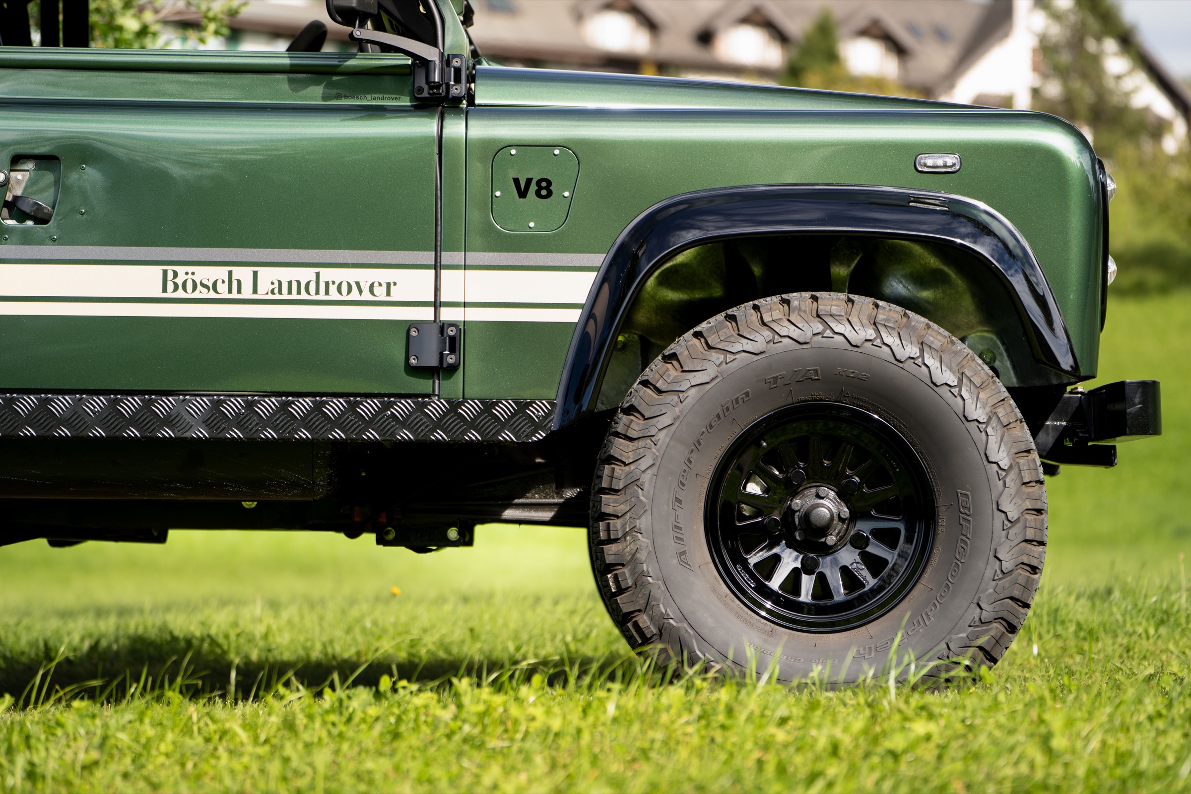 V8 Schriftzug und Vorderrad des Land Rover